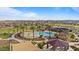 Beautiful community pool area with palm trees, splash pad, covered seating, and mountain views, perfect for relaxing or entertaining at 3187 E Pineapple Rd, San Tan Valley, AZ 85143