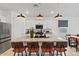 Bright kitchen features a large granite island with seating and modern pendant lighting above at 3187 E Pineapple Rd, San Tan Valley, AZ 85143