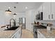 Modern kitchen with granite countertops, stainless steel appliances, and a large island with a sink at 3187 E Pineapple Rd, San Tan Valley, AZ 85143