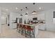 Well-lit kitchen features a large center island with bar seating and stainless steel appliances at 3187 E Pineapple Rd, San Tan Valley, AZ 85143