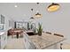 Open-concept kitchen with an island seamlessly connects to the living and dining areas at 3187 E Pineapple Rd, San Tan Valley, AZ 85143