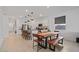 Open concept kitchen and dining area with modern lighting and seating around the island at 3187 E Pineapple Rd, San Tan Valley, AZ 85143