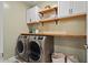 A well-lit laundry room with modern washer and dryer and plenty of storage at 3187 E Pineapple Rd, San Tan Valley, AZ 85143