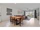Open-concept living room featuring tile floors, a leather sofa, and sliding glass doors to the backyard at 3187 E Pineapple Rd, San Tan Valley, AZ 85143
