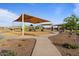 Enjoy the neighborhood playground with covered play structures, seating, and walking paths for outdoor fun and recreation at 3187 E Pineapple Rd, San Tan Valley, AZ 85143