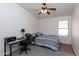 This bedroom includes a ceiling fan, carpet flooring, and a convenient workspace at 3206 W Knudsen Dr, Phoenix, AZ 85027