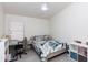 This cozy bedroom features a desk, light wood flooring, and a white ceiling fan at 3206 W Knudsen Dr, Phoenix, AZ 85027