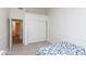 Bedroom featuring sleek wood floors, closet, and an ensuite bathroom at 3206 W Knudsen Dr, Phoenix, AZ 85027