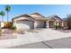 Attractive home with a three-car garage, a long driveway and well maintained landscaping and desert rock at 3206 W Knudsen Dr, Phoenix, AZ 85027