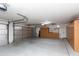 Spacious three-car garage with built-in storage cabinets, work bench, and ample room for vehicles and projects at 3206 W Knudsen Dr, Phoenix, AZ 85027