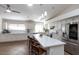 Open kitchen showcasing a center island with seating, stainless steel appliances, and tile flooring at 3206 W Knudsen Dr, Phoenix, AZ 85027
