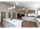 Well-lit kitchen with a large island, white cabinetry, tile floors, and an open view into the living area at 3206 W Knudsen Dr, Phoenix, AZ 85027