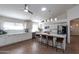 Bright kitchen featuring an island with bar seating, white cabinets, and stainless steel appliances at 3206 W Knudsen Dr, Phoenix, AZ 85027