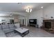 Spacious living room featuring a stone fireplace, a modern chandelier, and an open floor plan at 3206 W Knudsen Dr, Phoenix, AZ 85027