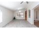 Spacious room with laminate flooring, neutral paint, a ceiling fan, and an arched entry and built-in bookcase at 3206 W Knudsen Dr, Phoenix, AZ 85027