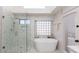 Inviting main bathroom featuring a glass enclosed shower and an alcove with a soaking tub at 3206 W Knudsen Dr, Phoenix, AZ 85027