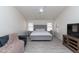 Relaxing main bedroom with natural light, a grey upholstered bed frame, and light wood floors at 3206 W Knudsen Dr, Phoenix, AZ 85027