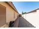 Long side yard with gravel, house access door and backyard gate, great for storage or pets at 3206 W Knudsen Dr, Phoenix, AZ 85027