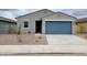 Charming single story home with a blue garage door and low maintenance desert landscaping at 3598 E Audrey Dr, San Tan Valley, AZ 85143