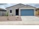 Charming single story home with a blue garage door and low maintenance desert landscaping at 3598 E Audrey Dr, San Tan Valley, AZ 85143