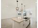Modern kitchen island featuring a granite countertop and stylish pendant lighting at 3598 E Audrey Dr, San Tan Valley, AZ 85143