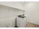 This laundry room is equipped with a modern, front-load washer and dryer at 3598 E Audrey Dr, San Tan Valley, AZ 85143