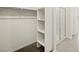 A walk-in closet with built-in shelving and a glimpse of the adjacent glass shower at 3598 E Audrey Dr, San Tan Valley, AZ 85143