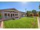 Expansive backyard featuring lush green grass, a brick patio, and well-maintained landscaping perfect for outdoor activities at 4030 N 54Th Pl, Phoenix, AZ 85018
