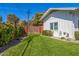 Private backyard with manicured lawn, a brick-lined garden, mature trees and a gated entrance at 4030 N 54Th Pl, Phoenix, AZ 85018