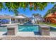 Stunning backyard featuring a refreshing pool, spa, outdoor kitchen, and fun playset at 4030 N 54Th Pl, Phoenix, AZ 85018