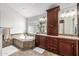 Main bathroom with soaking tub, tiled shower, granite countertops and custom cabinets at 4030 N 54Th Pl, Phoenix, AZ 85018