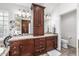 Bright main bathroom featuring double sinks, granite countertops, custom cabinets, and tile flooring at 4030 N 54Th Pl, Phoenix, AZ 85018