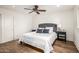 Bedroom featuring neutral tones, wood floors, ceiling fan, and a comfortable king-sized bed at 4030 N 54Th Pl, Phoenix, AZ 85018