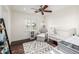Bedroom with hardwood floors, comfortable seating, a crib, and natural light streaming in through a window with shutters at 4030 N 54Th Pl, Phoenix, AZ 85018