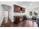 Bonus room with dark wood floors, wet bar, kitchenette, and a view of the backyard at 4030 N 54Th Pl, Phoenix, AZ 85018