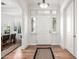Bright foyer with hardwood floors, a white front door, and views into the dining room at 4030 N 54Th Pl, Phoenix, AZ 85018