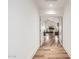 A hallway with wood floors leading into a spacious living area with a vaulted ceiling and fireplace at 4030 N 54Th Pl, Phoenix, AZ 85018