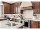 Close-up of the kitchen featuring stainless steel appliances, custom cabinets, and granite countertops at 4030 N 54Th Pl, Phoenix, AZ 85018