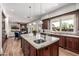 A bright kitchen with an island overlooking a dining area and living room with a fireplace at 4030 N 54Th Pl, Phoenix, AZ 85018
