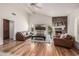 Inviting living room with a brick fireplace, hardwood floors, and lots of natural light at 4030 N 54Th Pl, Phoenix, AZ 85018