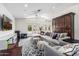 Spacious living room featuring hardwood floors, multiple seating areas, white walls, and ample natural light at 4030 N 54Th Pl, Phoenix, AZ 85018