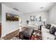 Living room features hardwood floors, white walls, TV, and comfortable seating at 4030 N 54Th Pl, Phoenix, AZ 85018