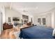 Bright main bedroom featuring hardwood floors, a sitting area with fireplace, and access to outdoor living at 4030 N 54Th Pl, Phoenix, AZ 85018