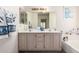 Bright bathroom features dual sinks, a large mirror, and plenty of cabinet space at 4102 W Fallen Leaf Ln, Glendale, AZ 85310