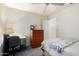 This cozy bedroom offers a simple interior with a ceiling fan and closet at 4102 W Fallen Leaf Ln, Glendale, AZ 85310