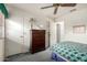 Bedroom with light walls, a window, dresser and bed, perfect for a relaxing retreat at 4102 W Fallen Leaf Ln, Glendale, AZ 85310