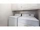 Bright laundry room with white washer and dryer; offering efficiency and convenience at 4102 W Fallen Leaf Ln, Glendale, AZ 85310