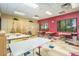 Bright arts and crafts room with ample workspace and storage cabinets at 42335 W Waterfall Way, Maricopa, AZ 85138