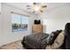 Cozy bedroom with a ceiling fan, window with blinds, and dresser with a TV at 42335 W Waterfall Way, Maricopa, AZ 85138
