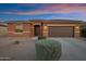 Charming single-story home featuring a two-car garage, low maintenance landscape and a neutral colored exterior at 42335 W Waterfall Way, Maricopa, AZ 85138